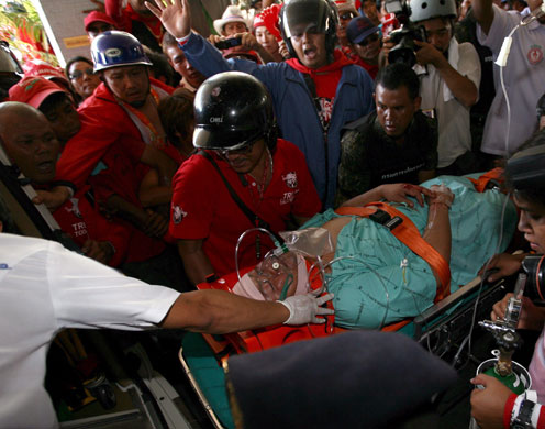 Thailand protests: Thai hospital officials carry a injured man 