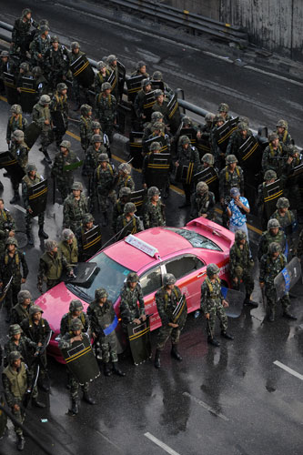 Thailand protests: Thai soldiers secure an area after they charged and fired gun shots.