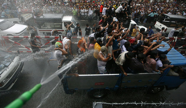 Burma water festival: Locals in vehicles get sprayed at Burma's new year water festival.