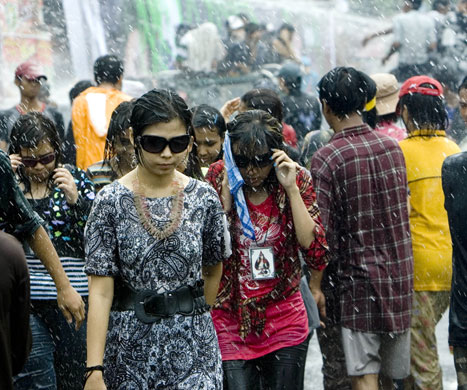 Burma water festival: Young people are sprayed during the annual water festival in Rangoon, Burma
