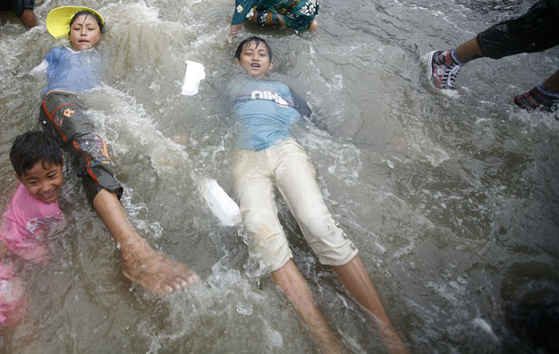 Burma water festival: Children play in water during Thingyan, Burma's new year water festival.