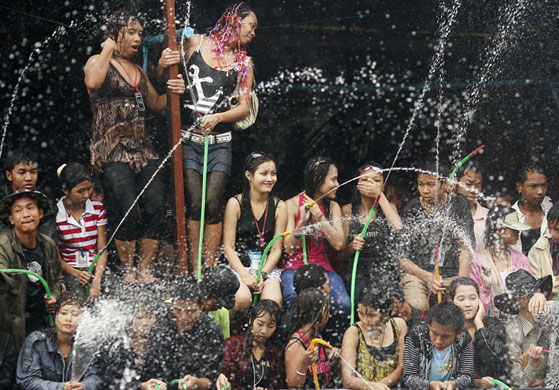 Burma water festival: Locals spray water during Thingyan, Burma's new year water festival.