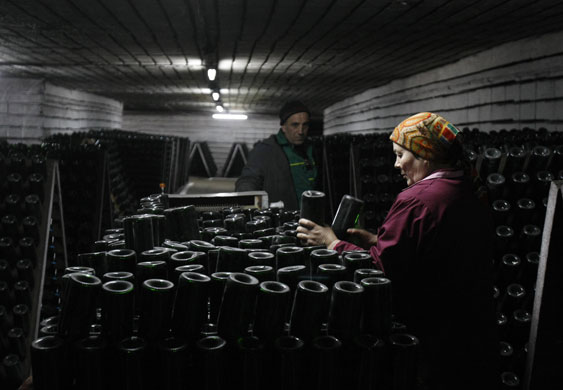 14 April 2009: Chisinau, Moldova: Employees prepare empty bottles in a Cricova wine cellar