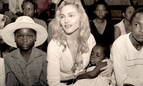 Sepia publicity photo of pop star Madonna with Mercy 