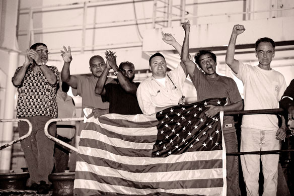 Sepia photography: Sepia: Crew members of the US merchant ship Maersk Alabama cheer