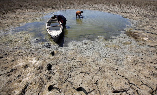 24 hours in pictures: Men fish in a partially-dried marsh in Iraq