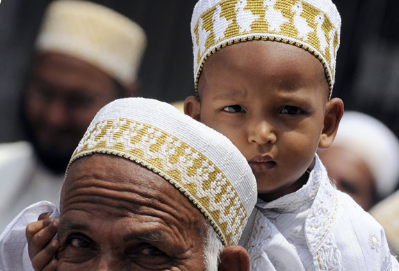 24 hours in pictures: Sri Lankan boy sits on his father's shoulders