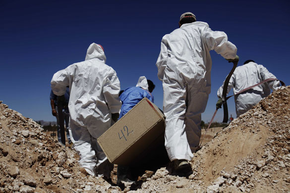 24 hours in pictures: Medical Forensic Service workers carry a box containing the remains