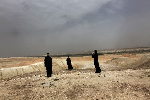 24 hours in pictures: Nun takes a picture of the Jordan valley desert