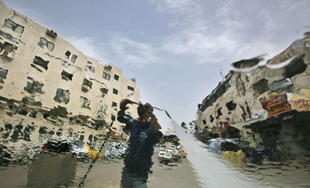 24 hours in pictures: Palestinian is seen through the windscreen of a car 