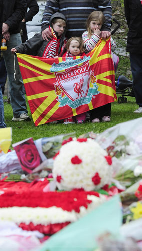 Hillsborough memorial: Children hold a flag during a service at the Hillsborough Memorial
