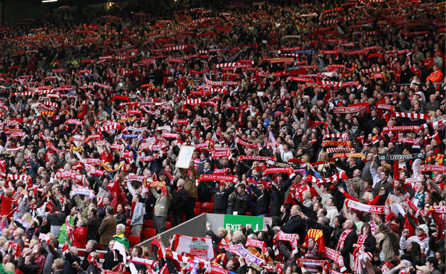 Anfield memorial service: Liverpool fans hold scarves and flags during a memorial service at Anfield
