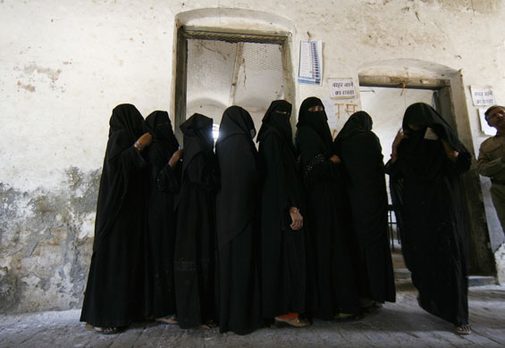 Elections in India: Woman walk out of a booth after casting their votes in Varanasi