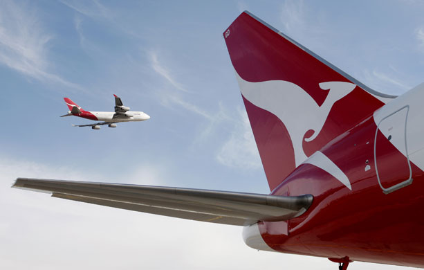 Week in business: A Qantas 767 passenger jet flies over Sydney Airport in Sydney, Australia. 