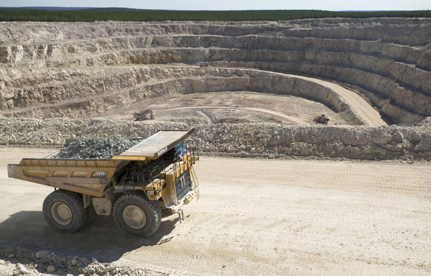 Week in business: A Caterpillar truck carries ore from the Sue E open pit uranium mine.