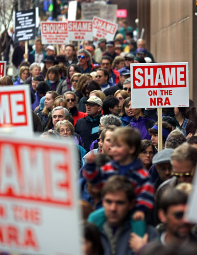 Columbine shootings: Proponents of gun control march in protest toward the NRA convention site