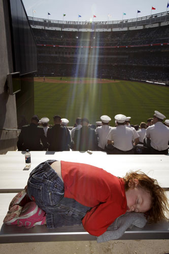 24 hours in pictures: A child sleeps at a baseball game in the new Yankee Stadium 