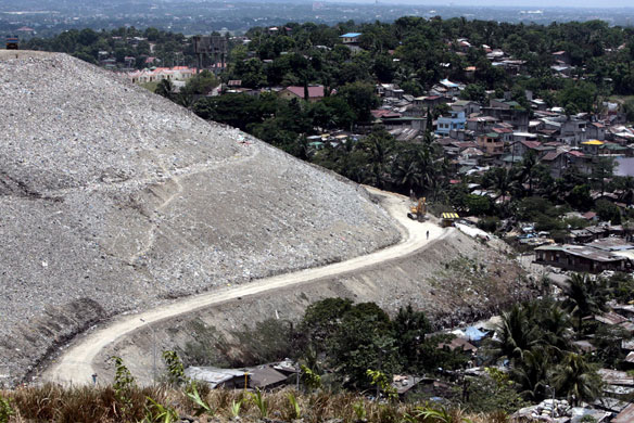 24 hours in pictures: Filipino homes are seen next to a  garbage dumpsite in Quezon City