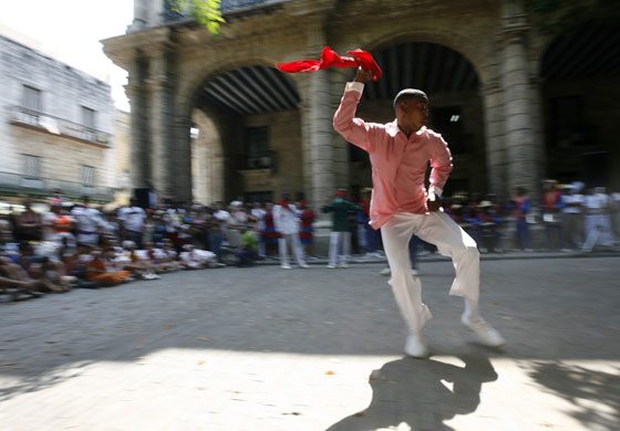 24 hours in pictures: A Santeria dancer religion performs at Havana's Plaza de Armas square