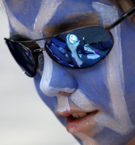24 hours in pictures: New York, USA: New York Yankees fan Michael Besson looks down at a ball.