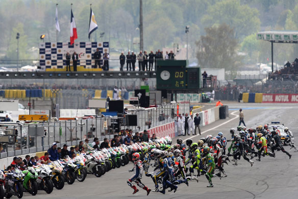 24 hours in pictures: Le Mans, France: Riders run to their motorbikes.