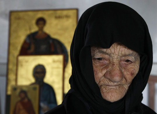 24 hours in pictures: Dipkarpaz, northern Cyrpus: Despina, a nun lights candles for Easter.