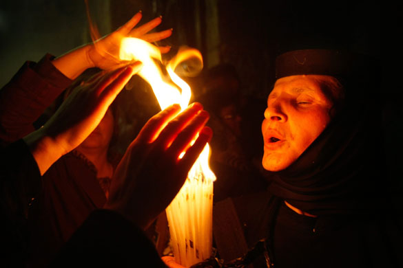24 hours in pictures: Jerusalem, Israel: Orthodox Christian pilgrims with candles