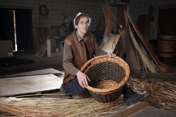 Basket making: P. H. Coate & Son: Jonathan Coate at work making a willow basket