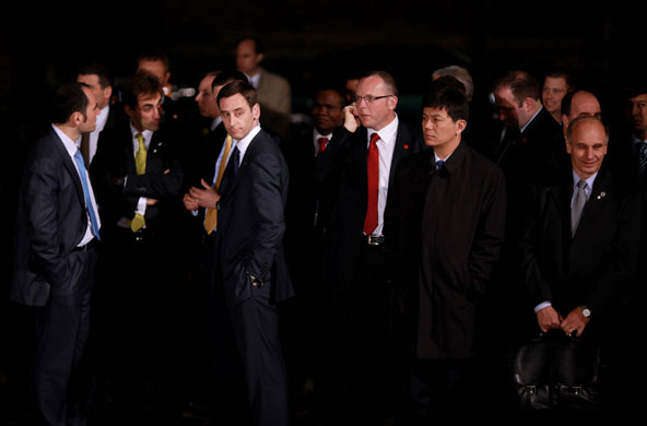G20 leaders dinner: Security staff and members of the G20 entourages await the delegates