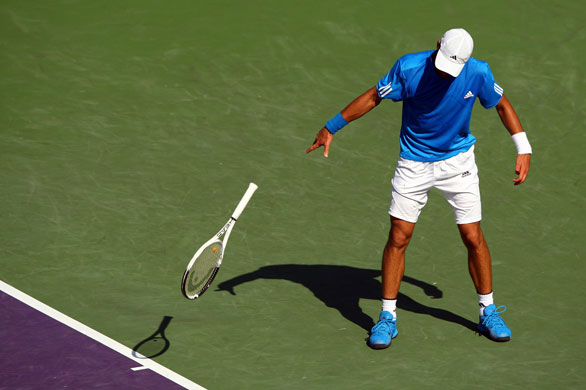 24 Hours in pictures: Novak Djokovic of Serbia throws his racquet 