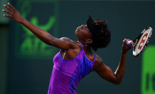 24 Hours in pictures: Venus Williams serves against Iveta Benesova of the Czech Republic