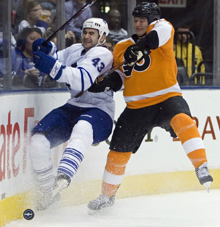 24 Hours in pictures: Toronto Maple Leafs' Jay Harrison is checked into the boards