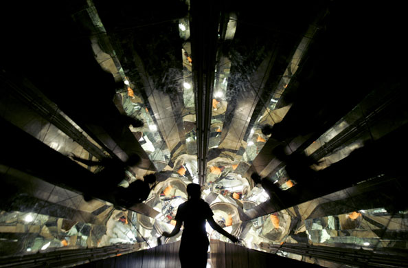 2 April 2009: St Louis, US: A girl walks through a hall of mirrors at the City Museum