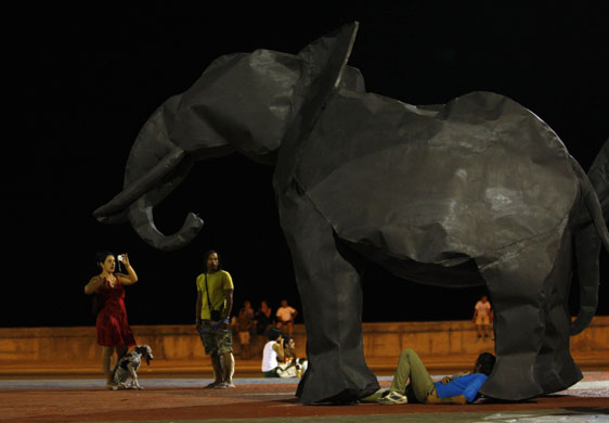 2 April 2009: Havana, Cuba: People take pictures of an elephant sculpture made of metal
