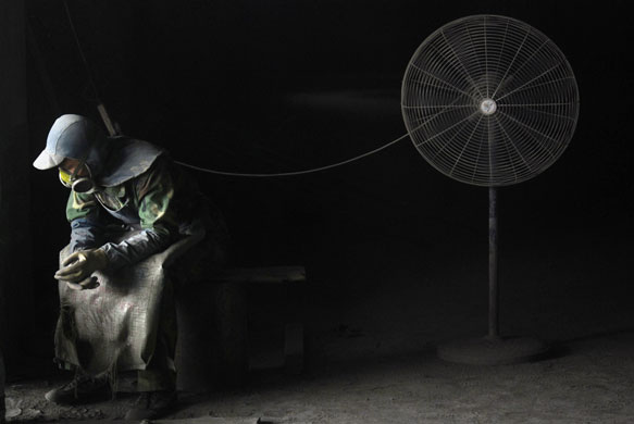 2 April 2009: Yingtan, China: A migrant worker rests at a cement plant