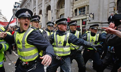 Police react to G20 protesters as they block access to a branch of RBS in 