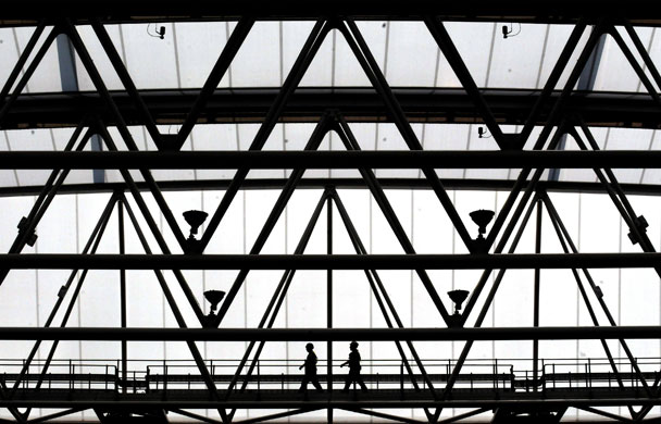 Wimbledon new roof: Workmen walk along in the rafters of the new roof on Centre Court.