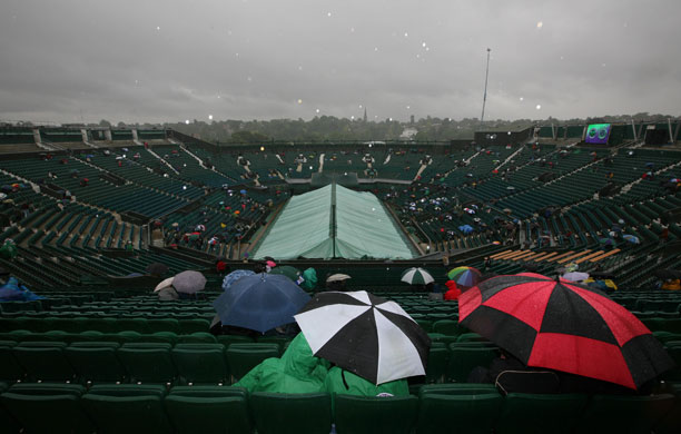 Wimbledon new roof: Determined tennis fans wait in the rain on centre court in 2007.