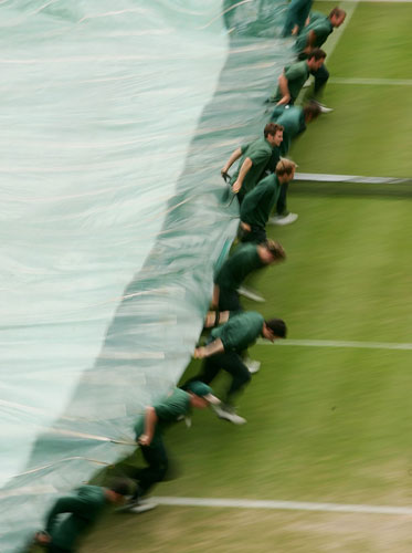 Wimbledon new roof: Ground staff run on with covers as rain delays the start of play 