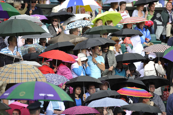 Wimbledon new roof: Spectators shelter under umbrellas as rain stops a match in 2008