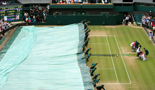 Wimbledon new roof: Serena Williams and Jie Zheng leave the court as the covers are brought on 