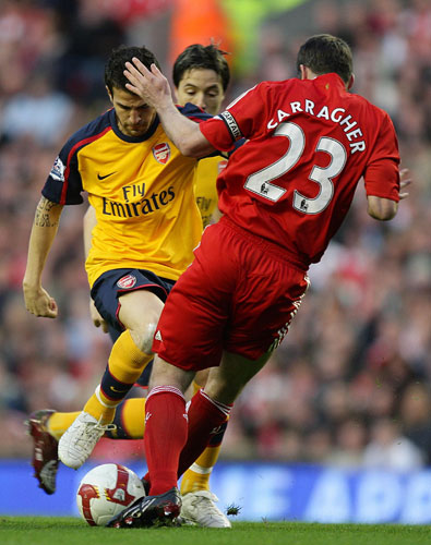 Liverpool v Arsenal: Cesc Fabregas and Jamie Carragher both go in hard 
