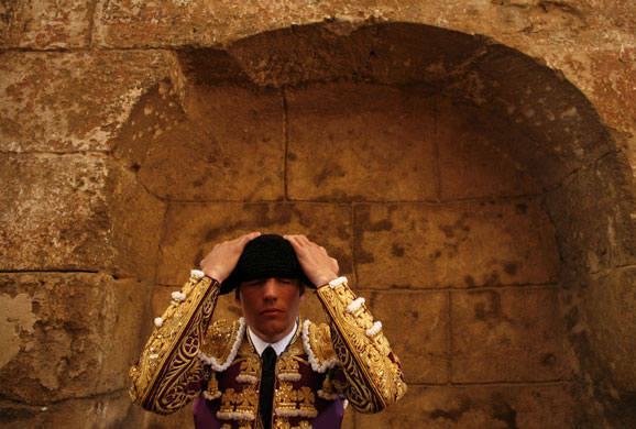 24 hours in pictures: Spanish bullfighter adjusts his hat before starting a bullfight in Seville