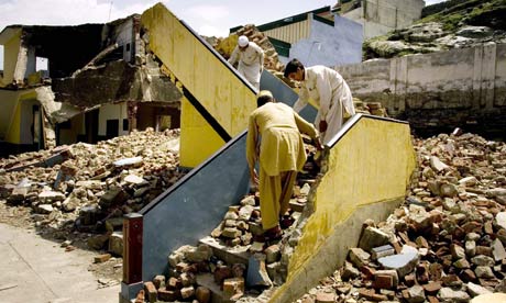 Students in Mingora sift through the rubble of their school allegedly destroyed by Taliban militants