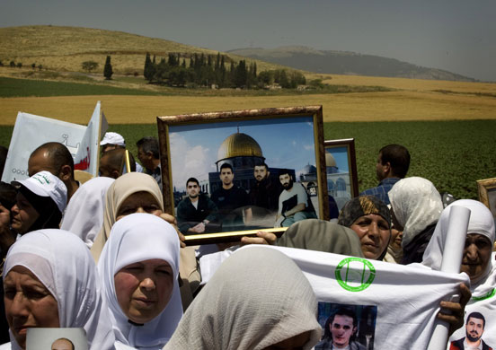 24 hours in pictures: Arab citizens of Israel hold pictures of their relatives 