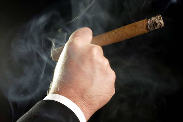 Week in business: Fat cat businessman smoking a large cigar