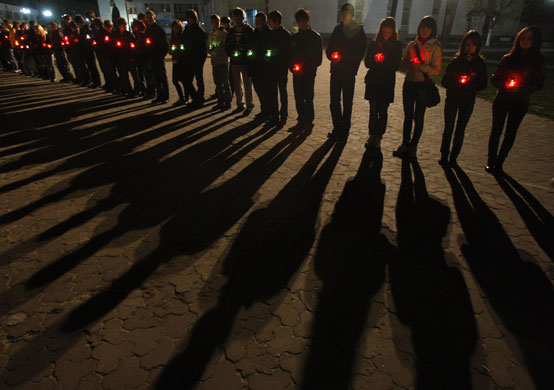 24 hours in pictures: Ukrainians attend a memorial for firefighters who died at Chernobyl 