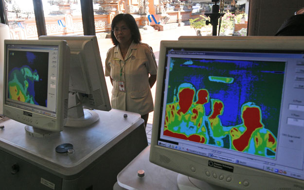 Swine Flu Outbreak: Arriving passengers are monitored at Ngurah Rai Airport in Bali, Indonesia