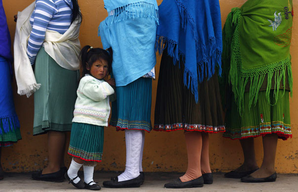 27 April 2009: Cangahua, Ecuador: A group of indigenous people outside a polling station