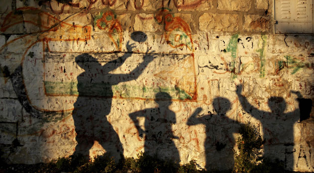 27 April 2009: Ramallah, West Bank: Shadows of Palestinians playing with a ball
